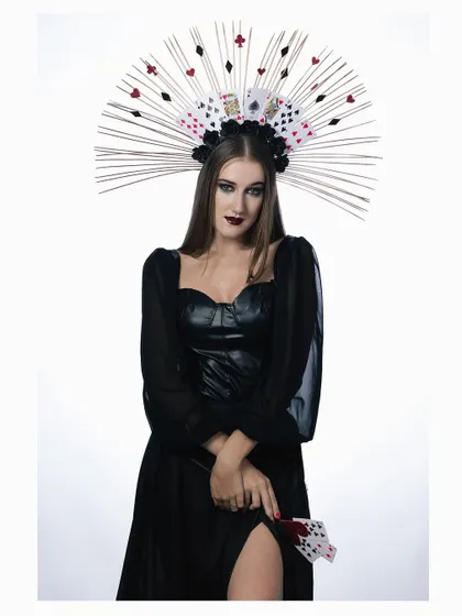 A full-length shot of the "Queen of Cards" character. The dramatic pose and flowing black dress create a sense of dark royalty and power.