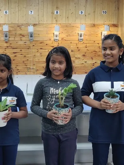 As part of a special event, our young shooters hold saplings at the range. We believe in nurturing not just shooting skills but also a sense of responsibility and community.