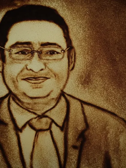 A detailed sand portrait created during the Girish Electrical Company event. These portraits are a unique way to honor key figures and create a memorable moment.