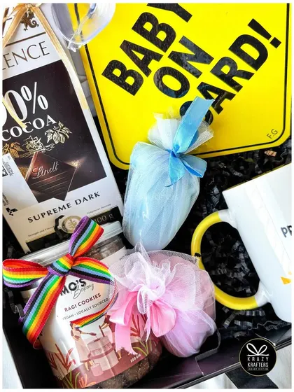 A close-up of the treats in our rainbow pregnancy announcement hamper, including dark chocolate and colorful sweet pouches.