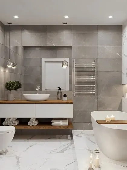 A bright and airy bathroom that feels like a personal spa. The space includes a freestanding tub, a floating vanity, and a mix of marble and gray tiles for a clean and elegant look.