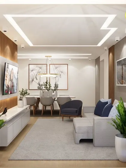 An open-plan living and dining area designed for modern apartment living. The layout is optimized for flow and function, with a clean-lined TV unit, a comfortable sofa, and a dining space defined by statement lighting.