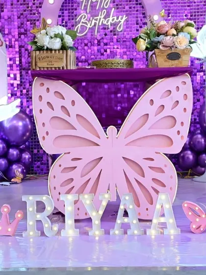 The personalized area of the purple butterfly setup, with light-up marquee letters spelling the birthday girl's name.