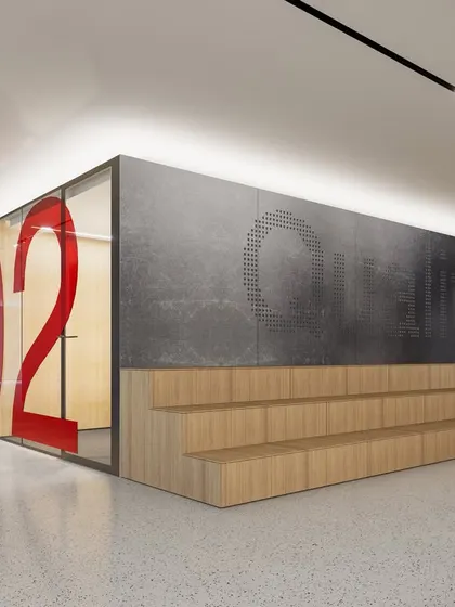 A closer look at the tiered seating and graphic-clad meeting room in the Vian Office. The design combines natural wood with industrial concrete textures and bold typography, creating a layered and visually engaging space that is both functional and expressive.