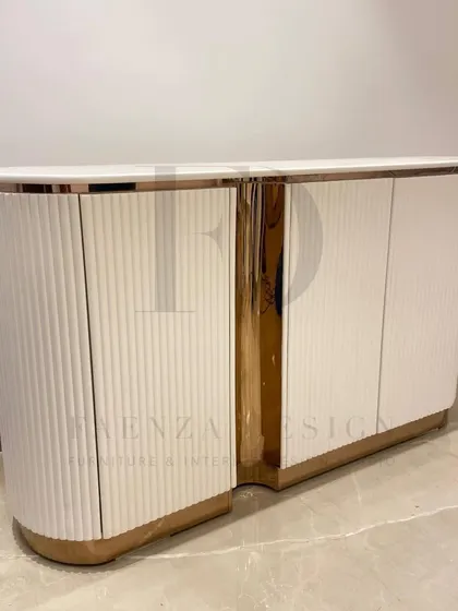 A custom-designed console for a foyer, featuring a curved silhouette, white fluted doors, and a rose-gold metallic finish. It's a perfect blend of modern design and classic glamour.