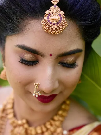 A close-up on the eye makeup for this Muhurtham look. I used warm gold tones to complement her jewelry and a deep red lip for a classic bridal feel.