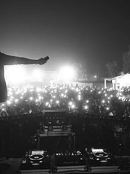 A powerful black and white shot showing the sea of lights from the crowd. This is the AfterLifeFam lighting up the night at Escapeland Festival.
