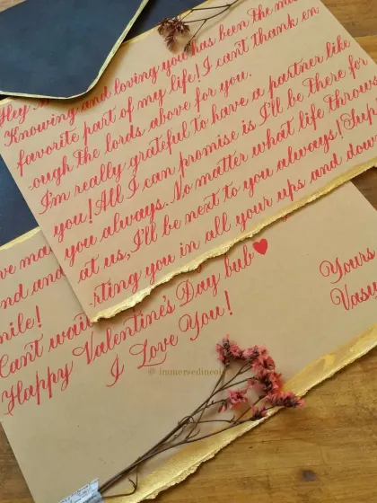 Another heartfelt Valentine's letter, this time using a vibrant red ink on kraft paper with a delicate gold foil edge. The contrast of the red, gold, and brown paper creates a warm and inviting look.