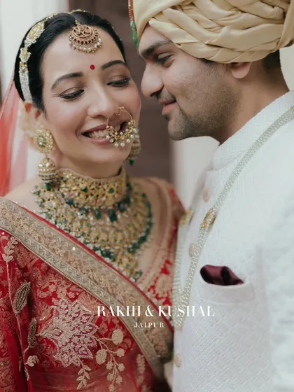A candid moment of joy between the bride and groom. Their smiles reflect the happiness of the day, captured in a classic, close-up portrait.