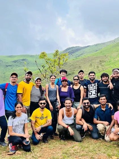 A group of trekkers posing on the green meadows of the Kudremukha trail. The camaraderie is as amazing as the views.