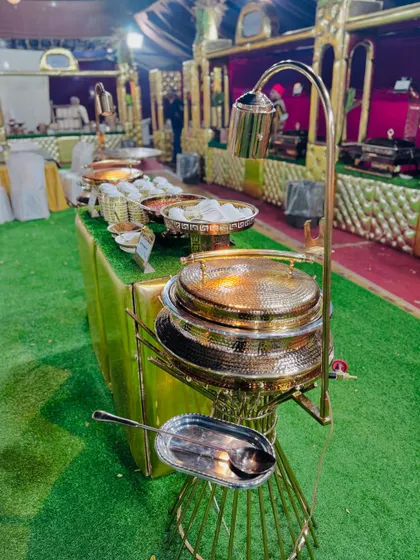 A detailed shot of the hammered copper and brass serving dishes used at my Mughlai buffet.