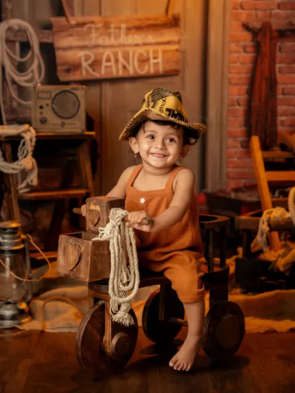 A happy smile from our little rancher, enjoying his imaginative playtime in the studio.