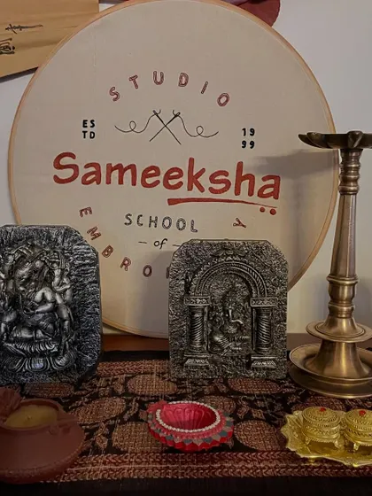 My embroidered logo displayed in the studio, surrounded by objects that inspire me. It's a reminder of my passion for this beautiful art form.