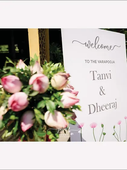 A close-up of the welcome board, with its elegant script and beautiful floral details.