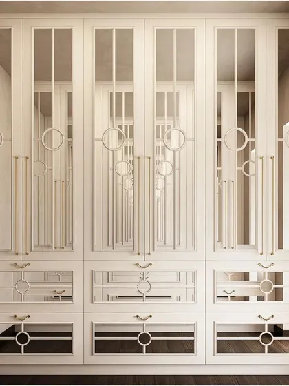 A stunning white wardrobe with mirrored and glass panels featuring intricate geometric overlays. This piece serves as both a functional closet and a decorative feature, adding glamour and light to the room.
