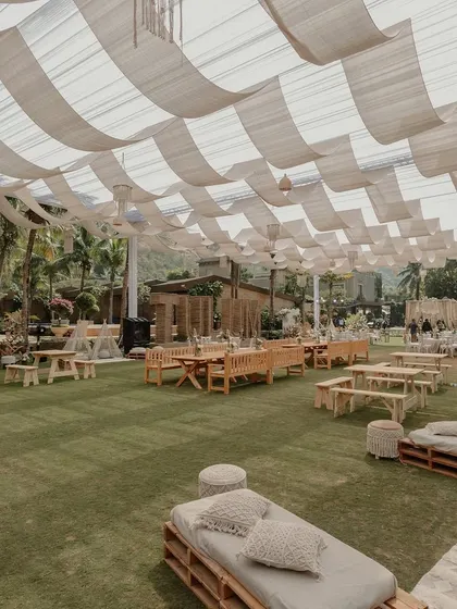 The full setup of our Tulum-inspired welcome lunch, with neutral tones, wooden furniture, and pampas grass creating a chic, bohemian vibe.