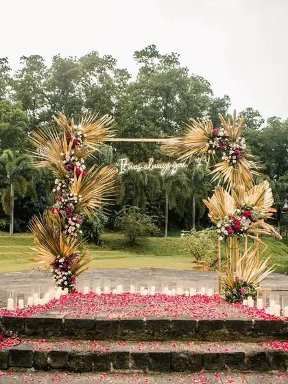 The proposal stage ready for the big moment, with a carpet of red rose petals and candles lining the steps.