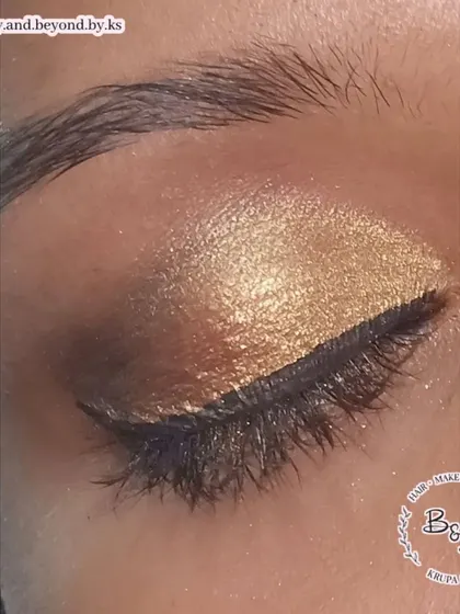 A detailed close-up of the golden brown smokey eye, highlighting the rich pigment of the gold eyeshadow on the lid.