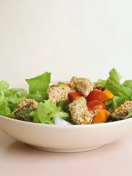My Orange and Sesame Chicken Salad is both light and flavorful. It features sesame-coated chicken on a bed of fresh lettuce with orange segments for a citrusy kick.