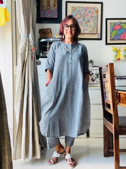 A full-length view of my comfy grey kurta set, styled with a statement silver necklace and my own pink bangles.