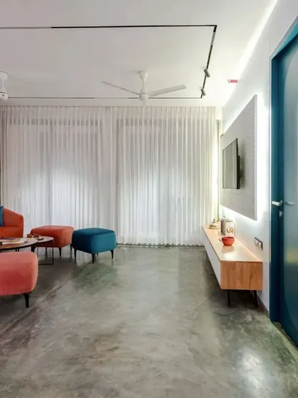 The apartment is designed with clean lines and modern track lighting, but the use of color and texture keeps it from feeling cold or sterile.