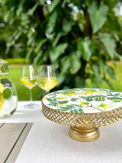 Serve up sweetness in style with our Borneo Botanical Cake Stand. The lush green print and golden filigree base create a stunning centerpiece for any dessert table.