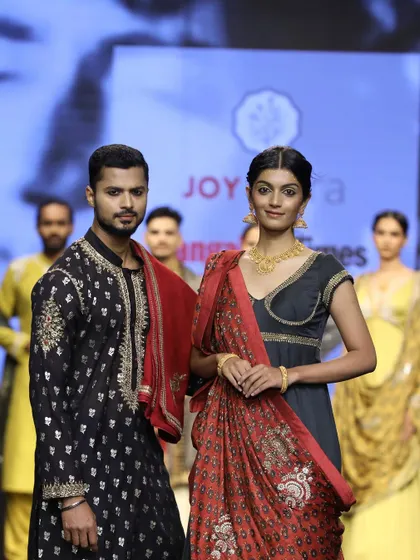 A final pose for the cameras at the Joy Mitra show, presenting a regal and cohesive look for the collection.