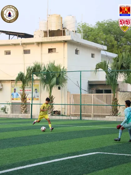 A player prepares to strike the ball, aiming for the corner of the net. We teach our players the technique to shoot with both power and precision.