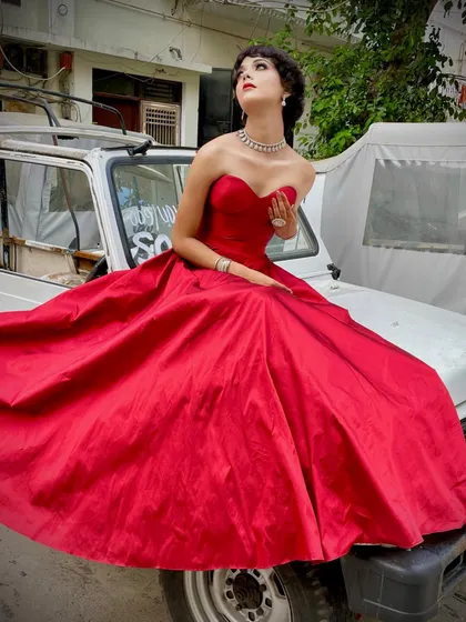 Another shot from the same series, capturing the classic Hollywood glamour of the red gown. The fit and structure are key to achieving this elegant silhouette.