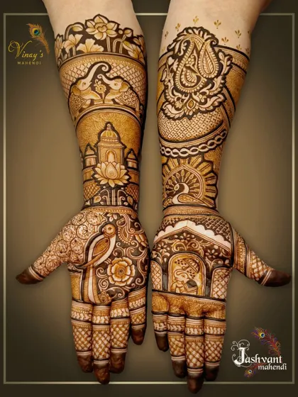 A full view of the stunning mehndi we did for the groom's sister. The design is asymmetrical, with one hand featuring a portrait and the other a beautiful paisley motif.