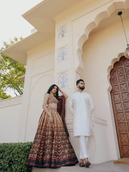 A stylish portrait of Sandy and Darsh at the Oberoi Sukhvilas. The clean lines of the architecture complement their modern yet traditional aesthetic.