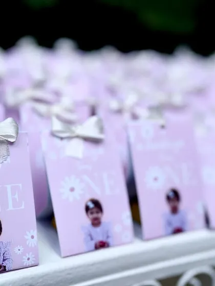 Personalized party favors are a sweet way to thank your guests. For Aadhya's first birthday, I designed these custom chocolate bar wrappers featuring her photo, perfectly matching the fairy theme.