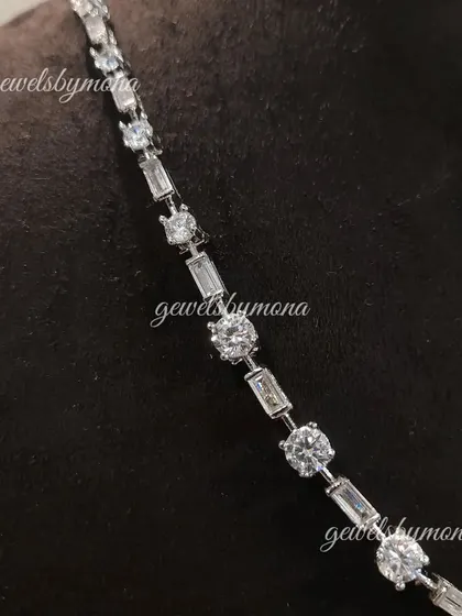 The clean, modern elegance of a diamond tennis necklace. This piece features a seamless line of round and baguette-cut diamonds, offering a sophisticated sparkle that is perfect for any occasion.