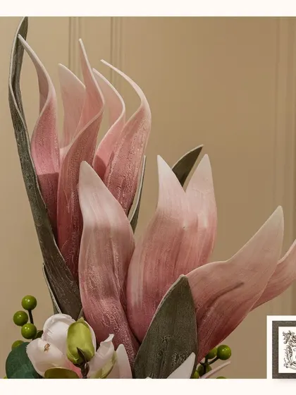 The unique, sculptural quality of these pink artificial flowers adds a modern and artistic touch to the arrangement.