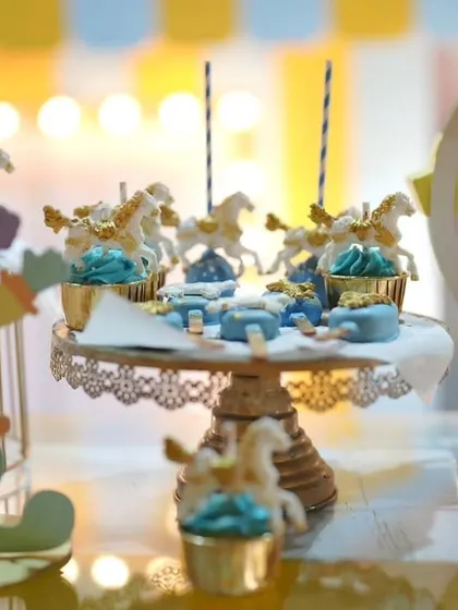 Themed desserts are a must. These cupcakes and cakesicles for a carnival party are topped with miniature carousel horses, tying the whole theme together.