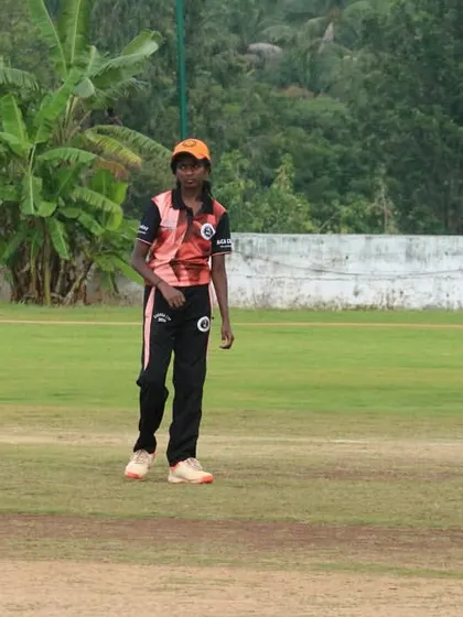 A young fielder patrols the outfield during a Dasara Cup game.