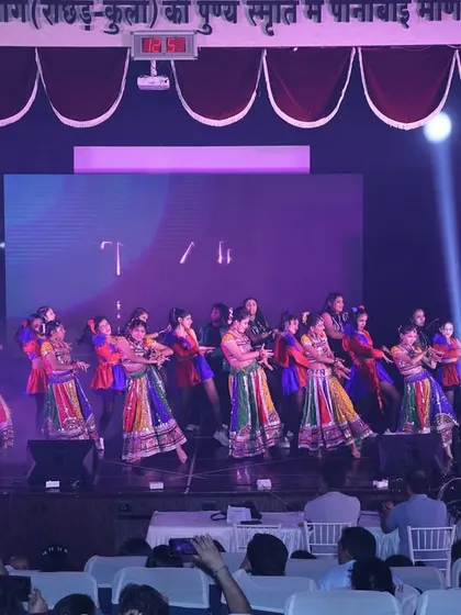 The stage filled with color and movement during the Tarulya finale. This shot captures a large group performance, showcasing the scale of our show.