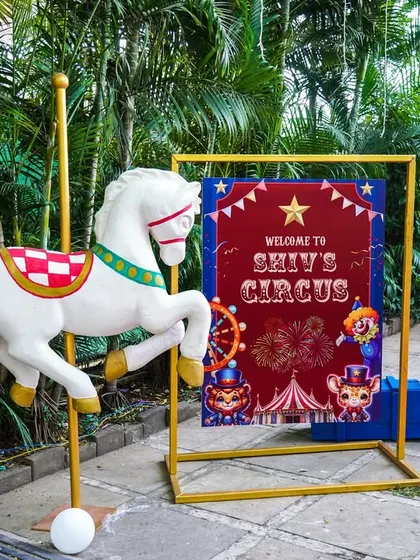 A welcoming entrance to 'Shiv's Circus', with a red carpet and a classic carousel horse.
