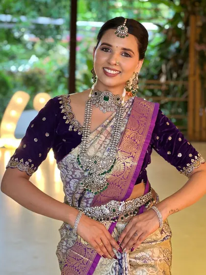 A happy, smiling bride looking absolutely stunning in her complete reception attire.