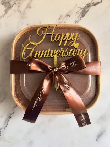 My Tiramisu is perfect for any occasion, including anniversaries. Here it is, beautifully packaged and ready for gifting with a custom "Happy Anniversary" topper.