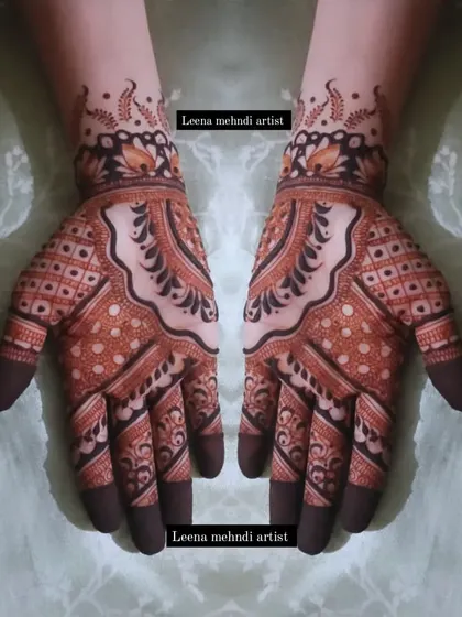 A striking design that uses bold, dark-filled patterns to create a strong visual impact. The intricate check patterns on the fingers and palms contrast beautifully with the flowing motifs on the back of the hand.