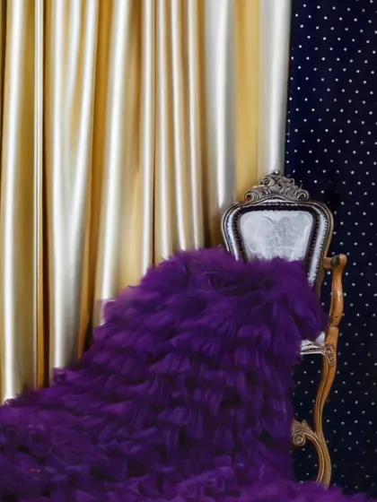 A shot of our premium purple ruffle gown, showcasing its rich texture and volume.