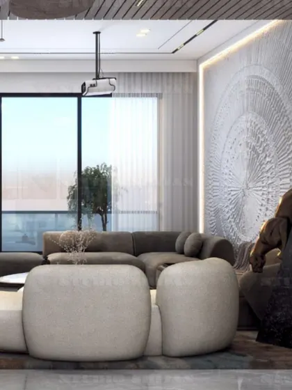 Another angle of the lounge, showing the comfortable, low-slung sofa and the large window that provides ample natural light.