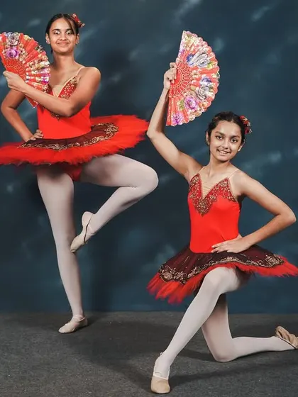 Dancers from our 'Don Quixote' performance. The use of fans as props adds a fiery, Spanish-inspired flair to the classic ballet choreography, showcasing both technique and personality.