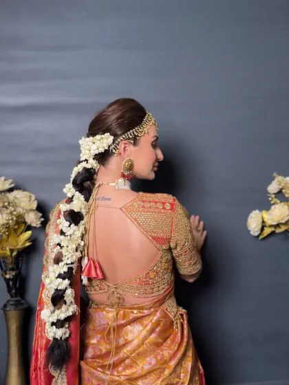 A back view of the classic South Indian braid, adorned with fragrant jasmine flowers all the way down.