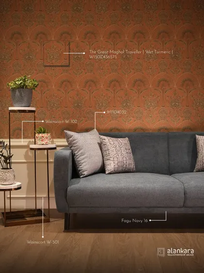 This image shows how I help clients visualize the final look. I've annotated the photo with the specific codes for the Nilaya wallpaper ('The Great Mughal Traveller'), the sofa fabric, and accent colors, ensuring a perfectly coordinated design.