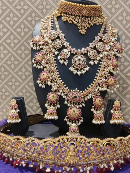 A full view of the Kempu bridal set with jhumka hangings, including a matching choker and vaddanam.