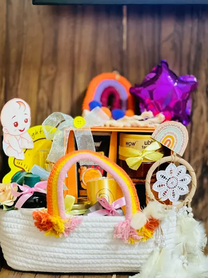 This cheerful hamper for a mom-to-be has a rainbow theme. It's packed in a white woven basket and includes skincare products, a dreamcatcher, and other pampering items to brighten her day.