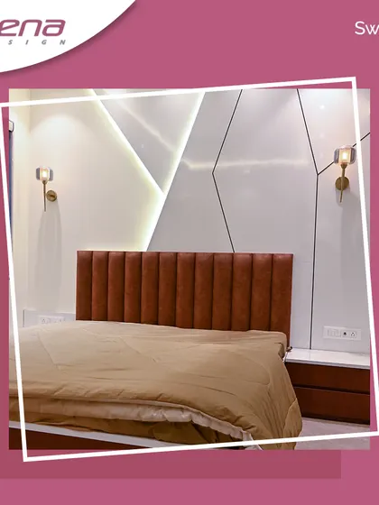 A modern bedroom with a striking accent wall featuring geometric patterns and wall-mounted lights. The leatherette-paneled headboard adds a touch of luxury.