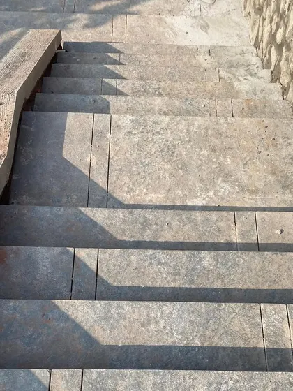 Detail of the stone steps at Ranch House during construction, highlighting the raw, earthy texture of the local materials.
